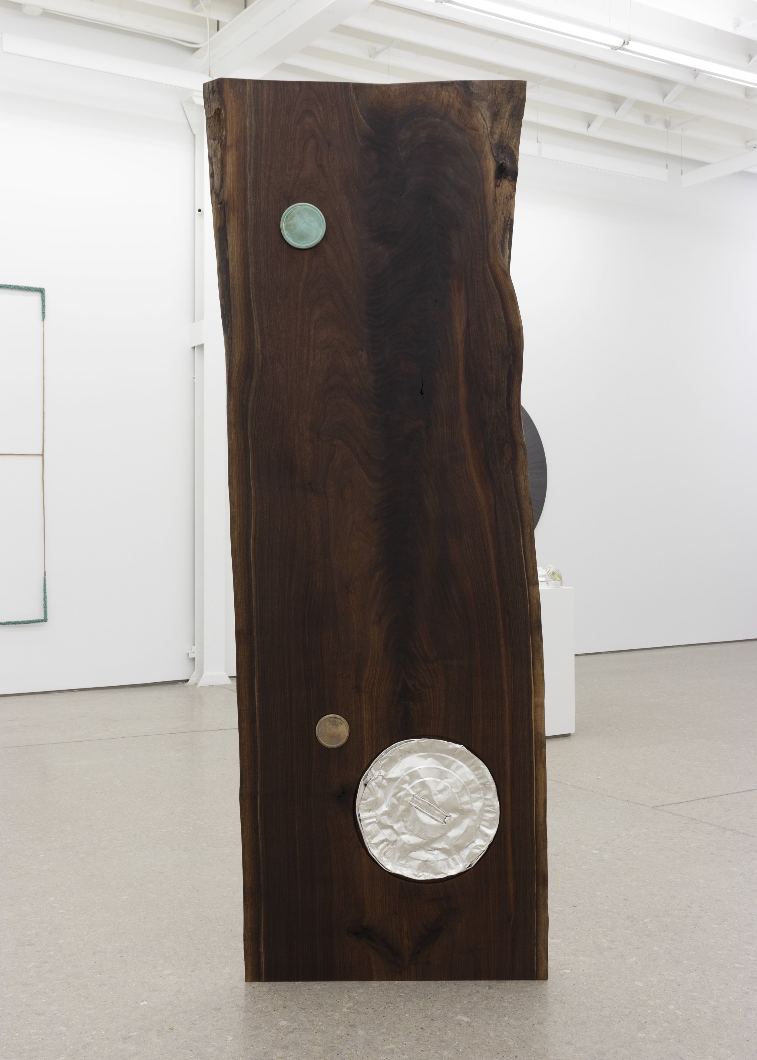   Untitled , 2022   oil on panel, silver on steel, found jam jar lid and bronze on walnut   86 x 31 x 3 in 