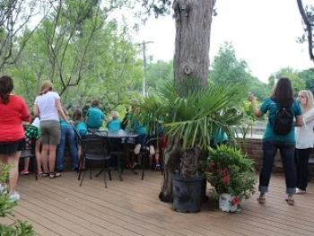 Around the corner is the outdoor deck. This area overlooks much of the Linnaeus Teaching Garden and is shaded by Eastern Red Cedars.