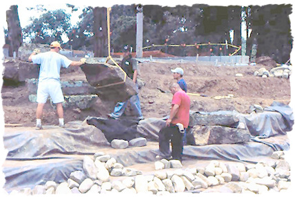 Placing a large boulder.