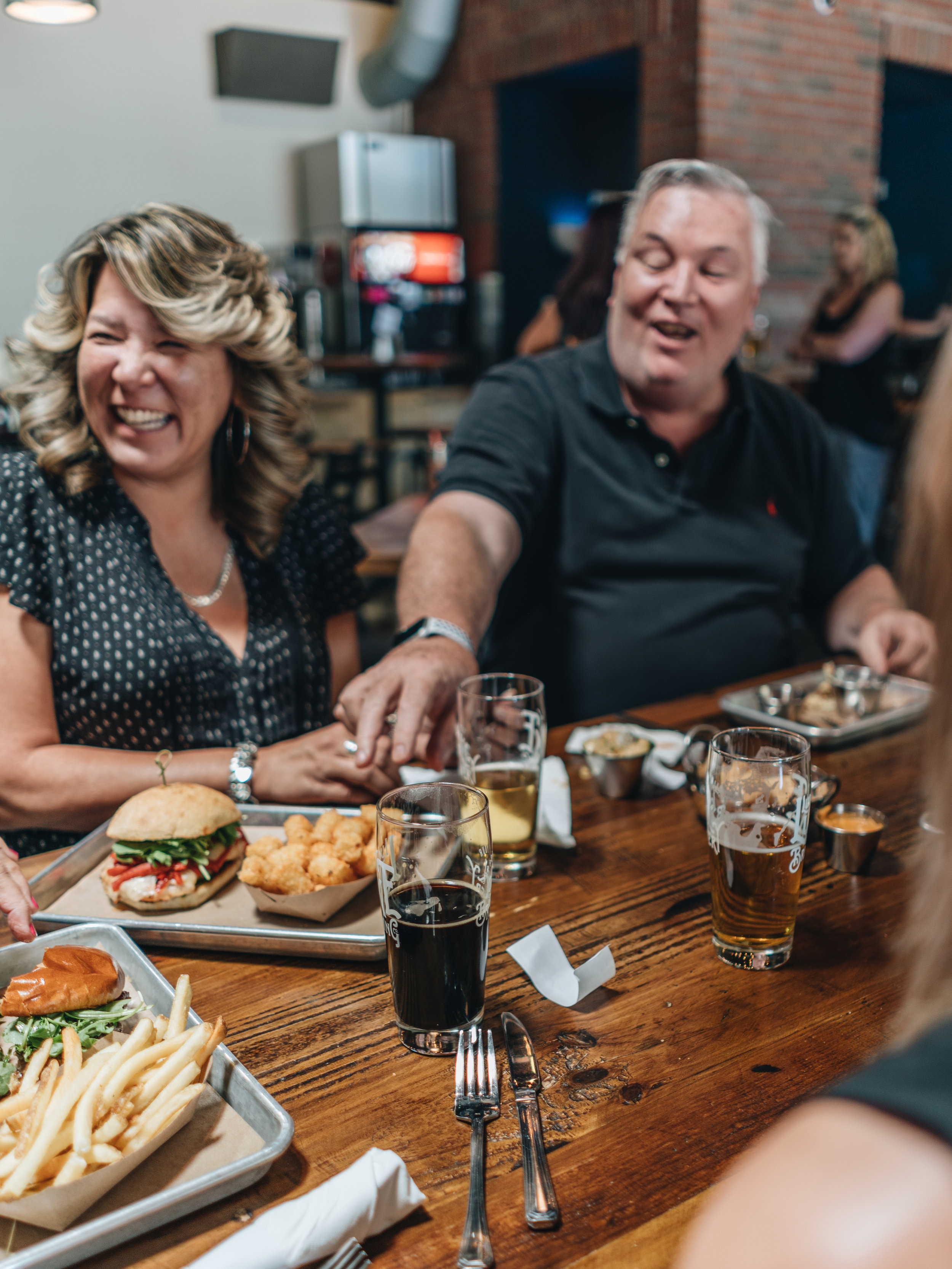  friendly faces sharing laughs over dinner and delicious beer at the Lucky Luke Brewpub 