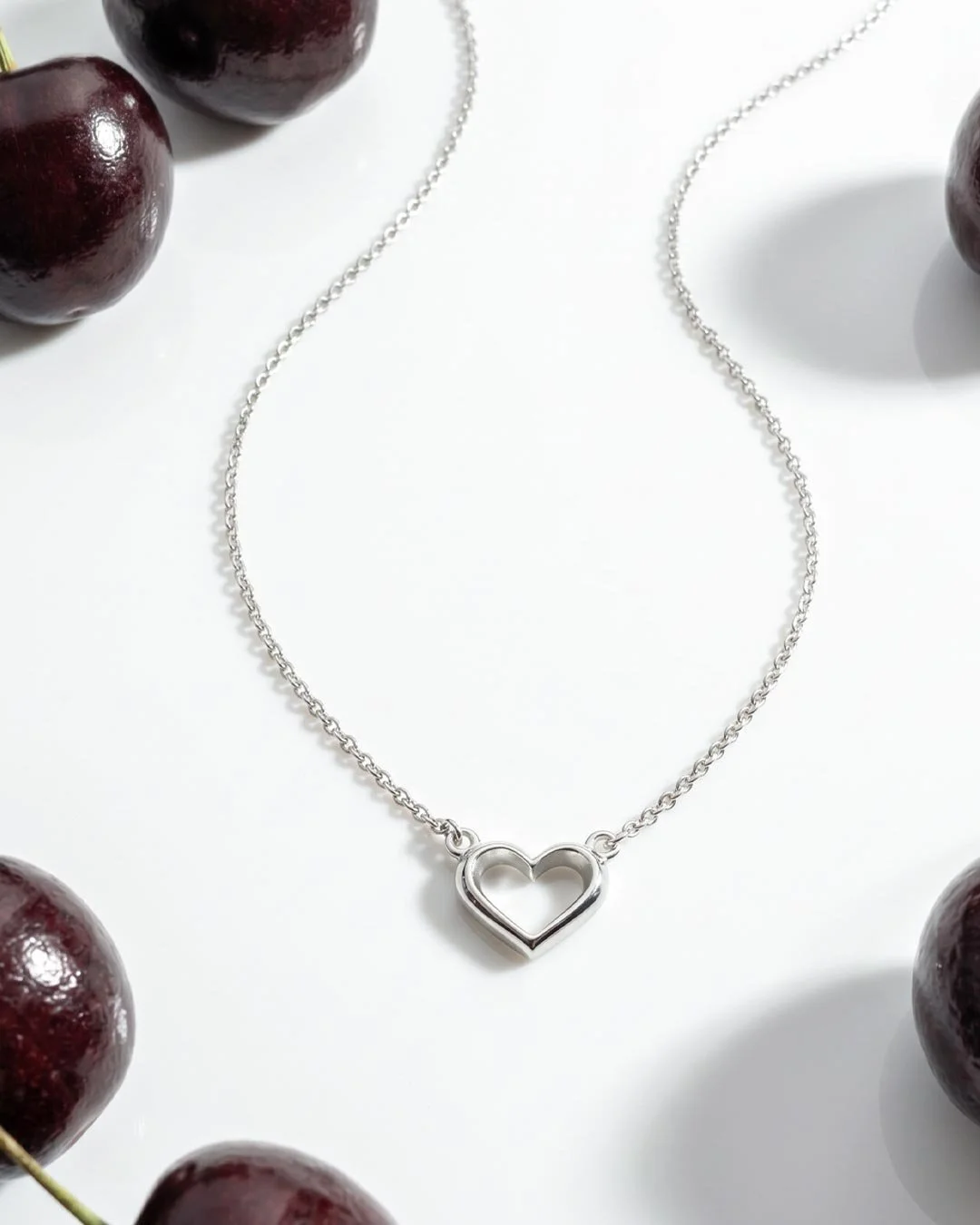 Love_Silver_Heart_Fine_Outline_Mini_Necklet_on_styled_background.jpg