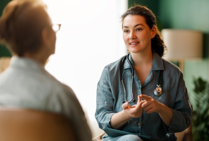 Female patient with female doctor discussing treatment for skin conditions