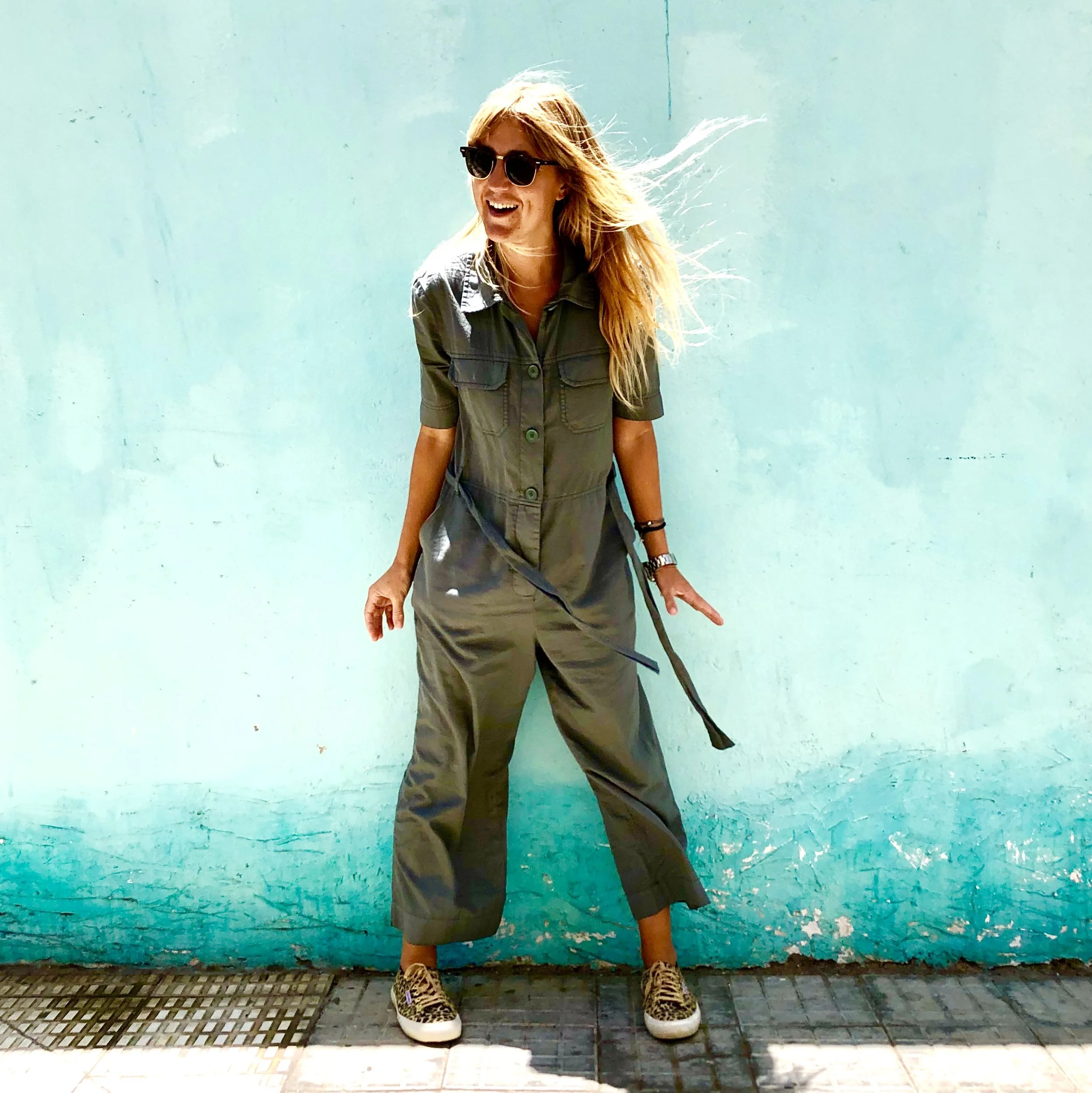 Here I am - posing in my adult babygro in front of a pretty wall.