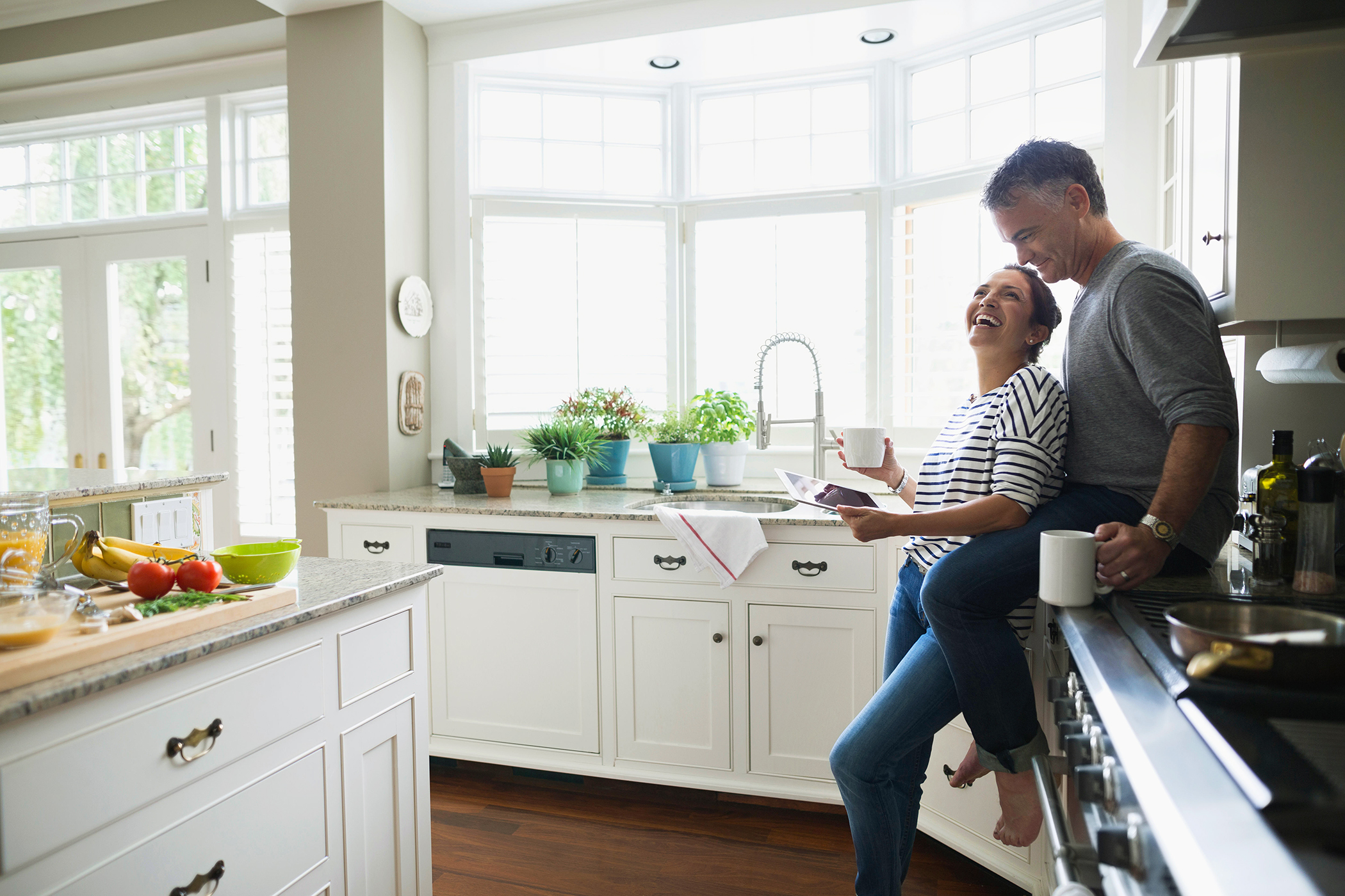 couple in kitchen laughing_enjoy life again_pain free.jpg
