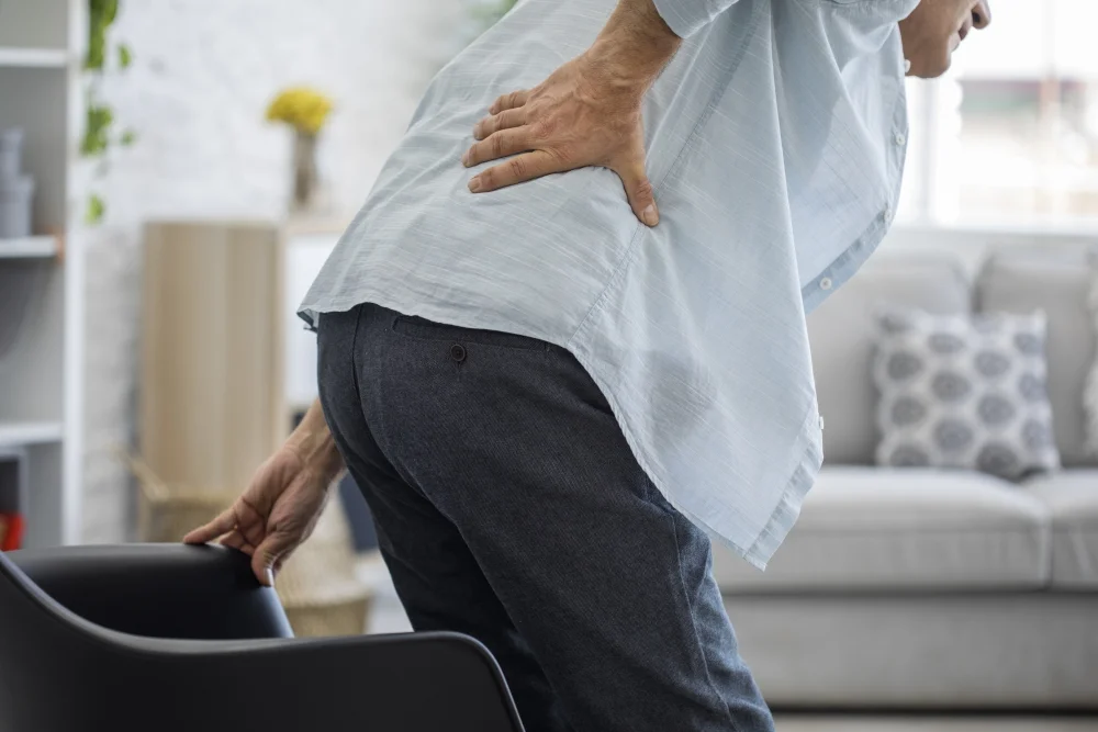 elderly man getting up from chair low back pain_degenerative-disk-disease-ddd_integrated-physicians-medical-group_the-integrated-brain-and-spine-center-for-functional-neurology-and-medicine.jpg