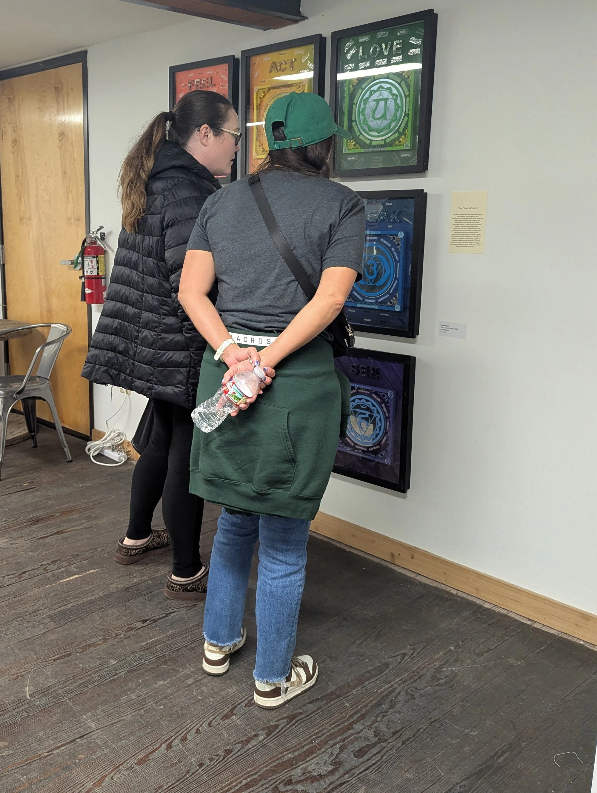 Attendees examine an installation at the exhibition opening