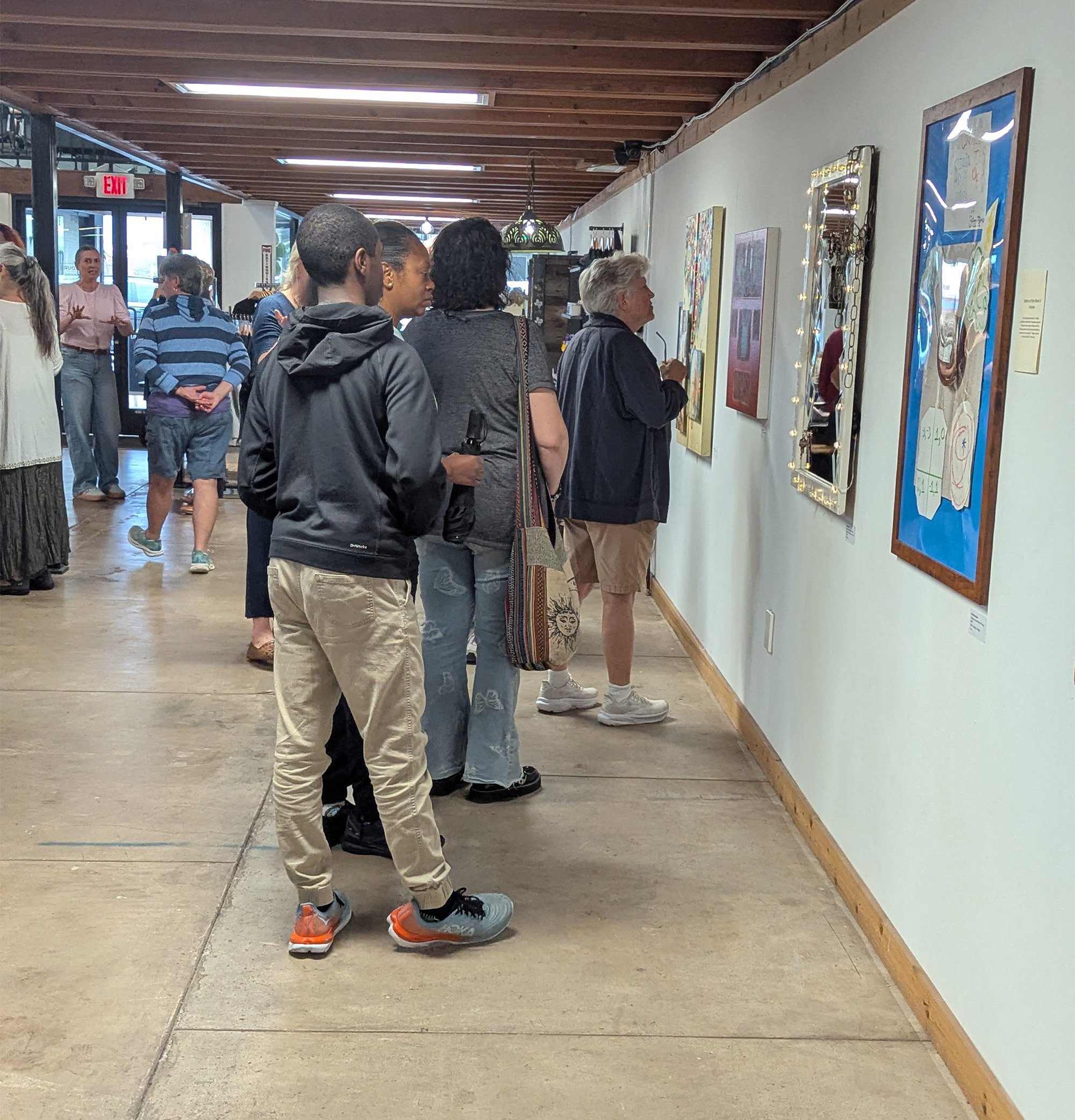 Attendees looking at art at the Member Exhibition opening
