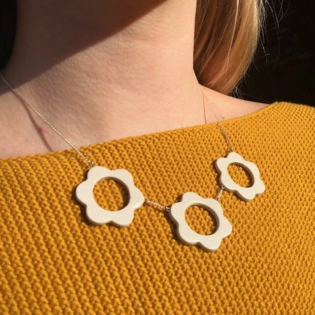Porcelain flower necklace sterling silver chain on model.jpeg