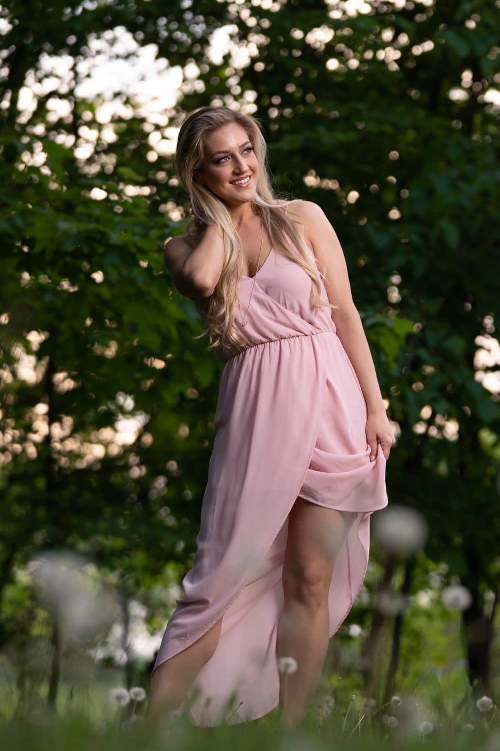  Blonde in pink dress standing in woods 