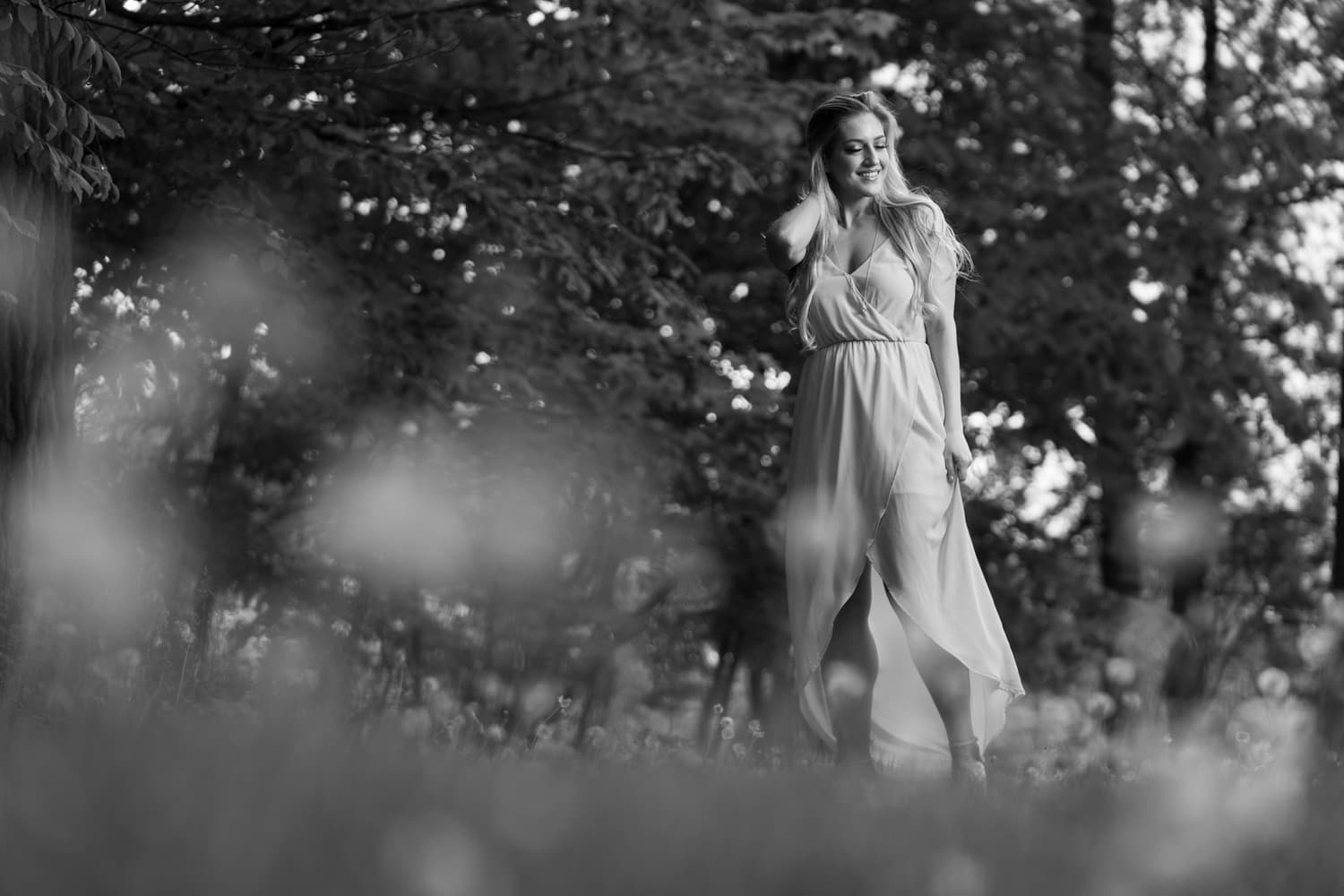  Black and white image of blonde woman in pink dress 