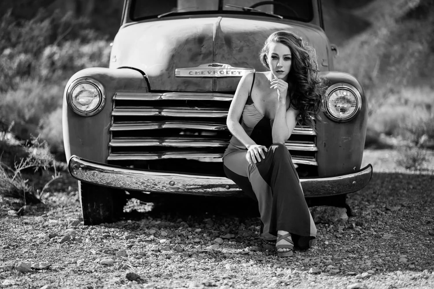 Portrait of model Savvy Morton sitting on bumper of vintage chevy pickup truck