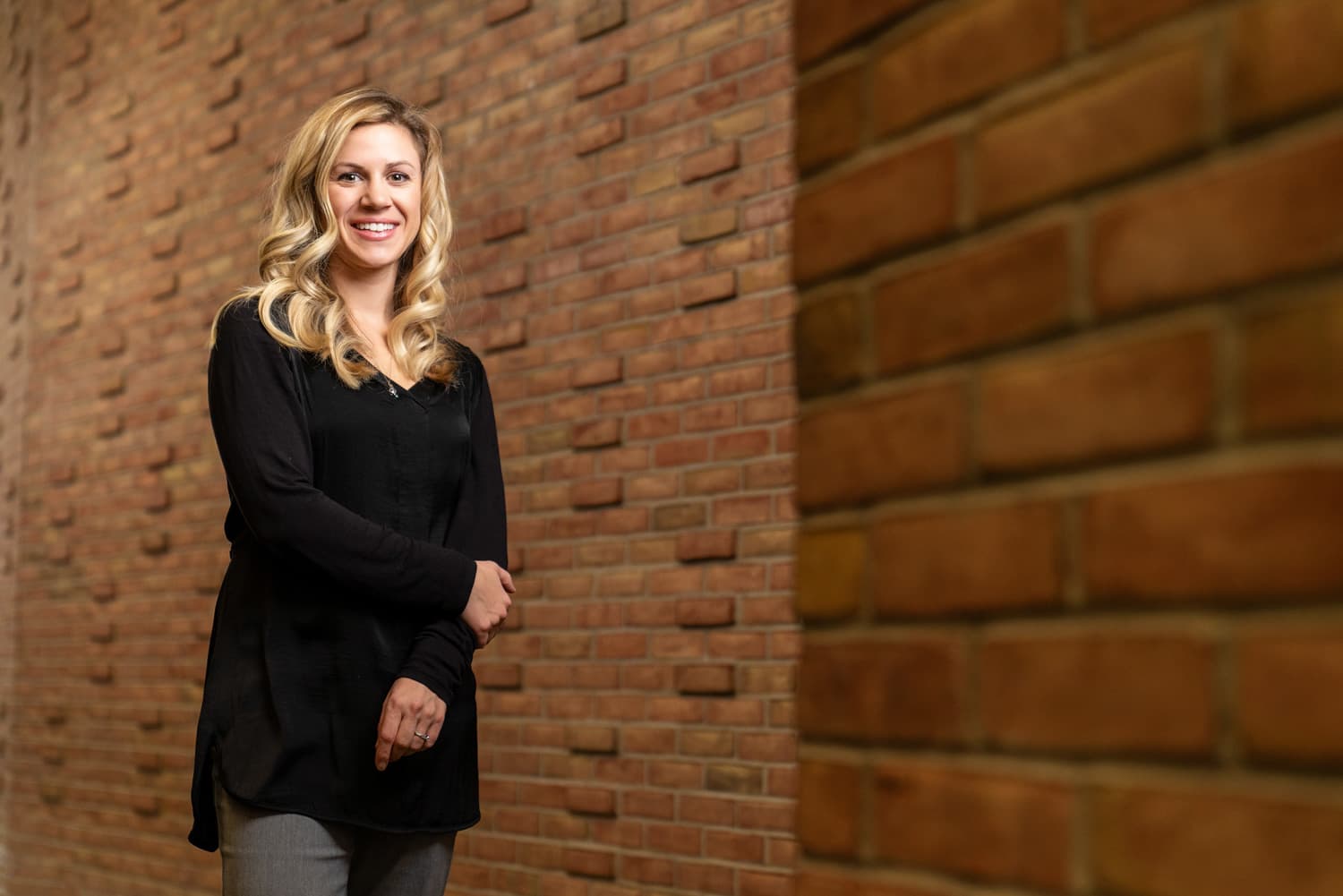  advisor standing in front of bricks 