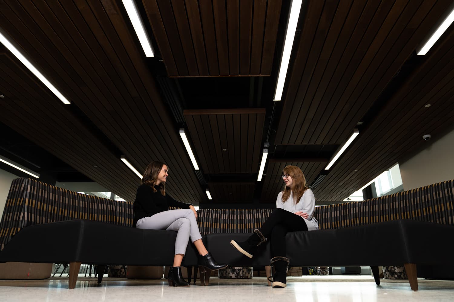  student and advisor talking on couch 