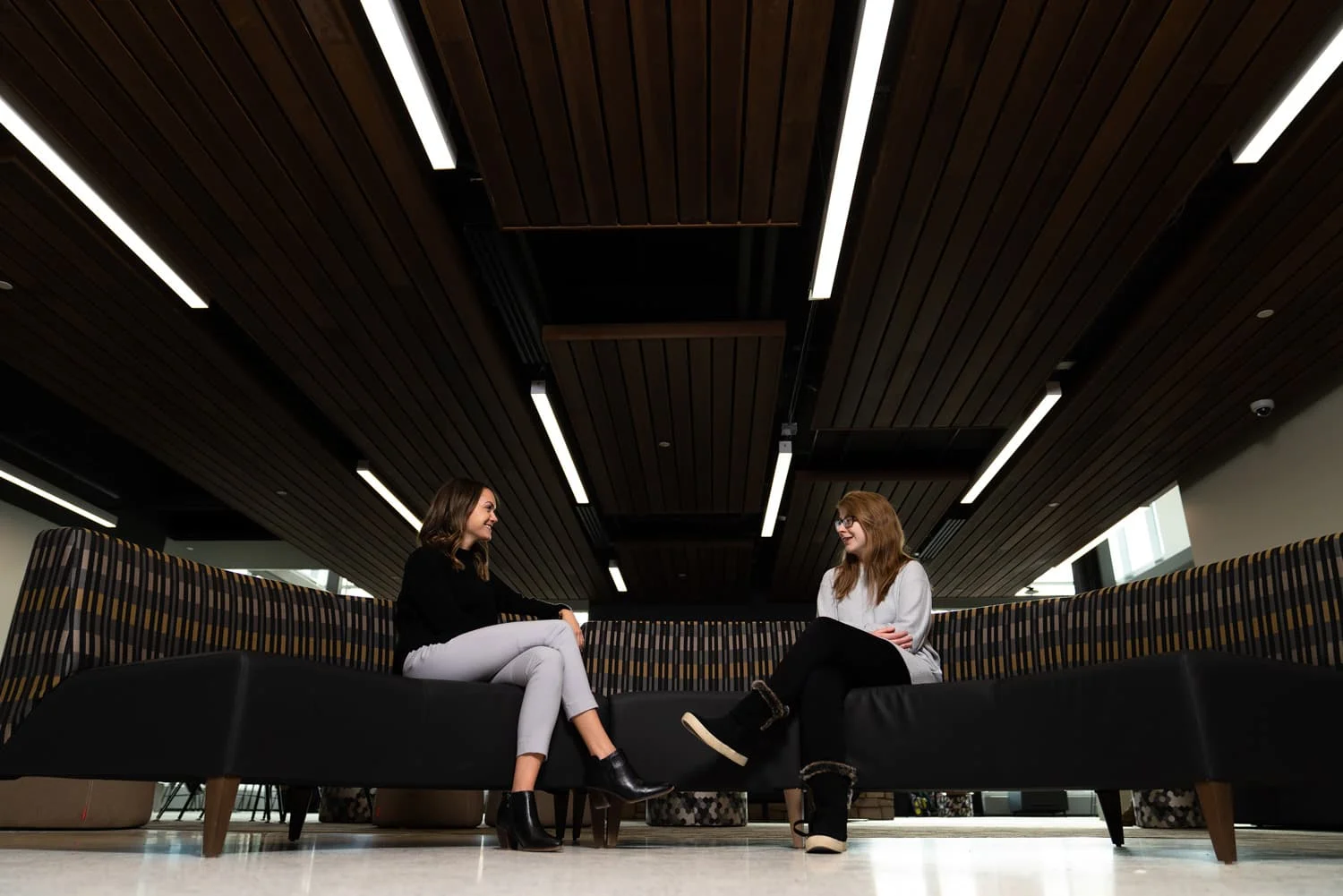 student and advisor talking on couch