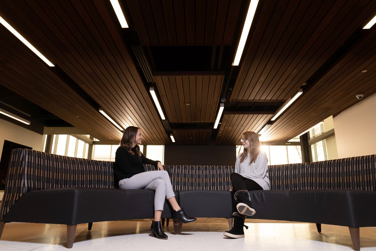  student and advisor talking on couch 