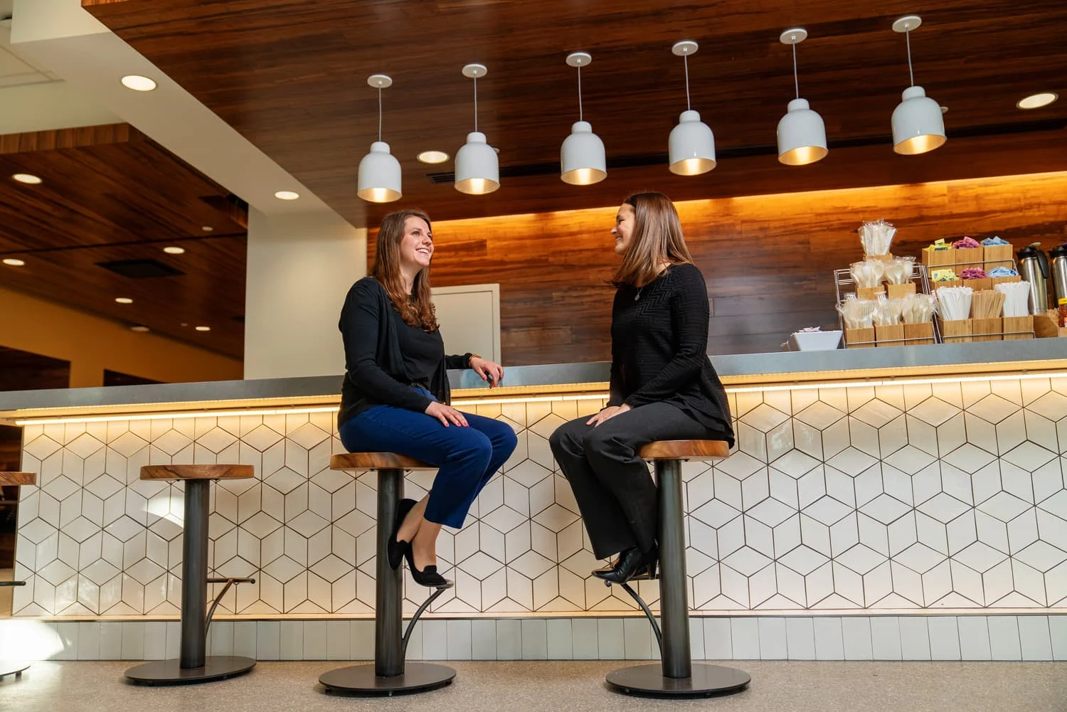 Two people talking at cafe counter