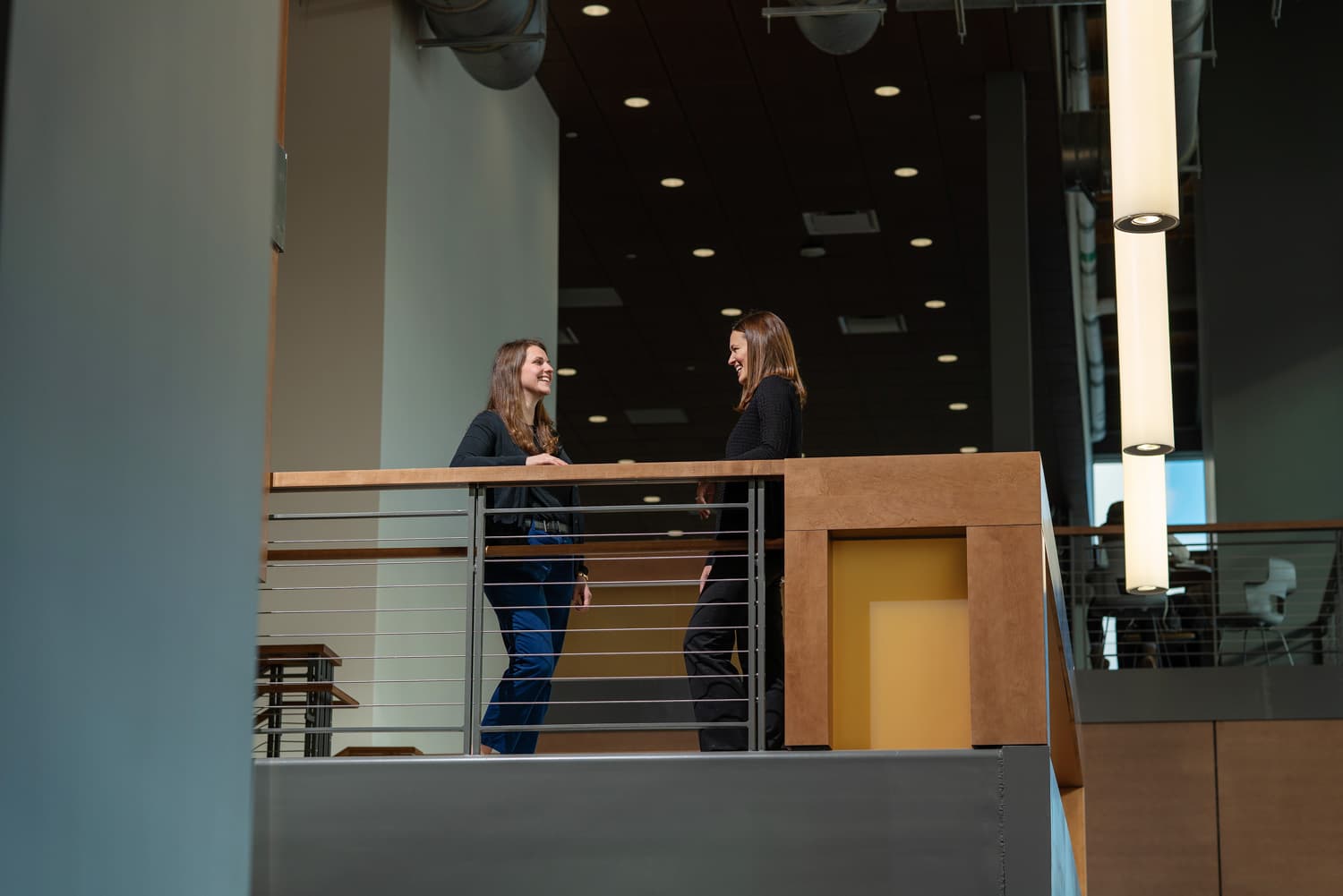  two people talking in industrial building 