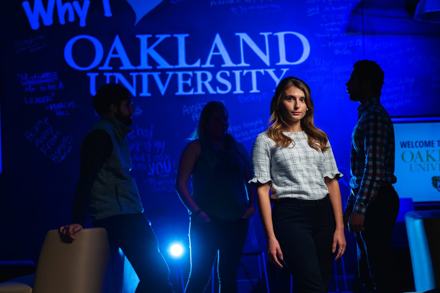  Portrait of advisor with student silhouettes and blue background 