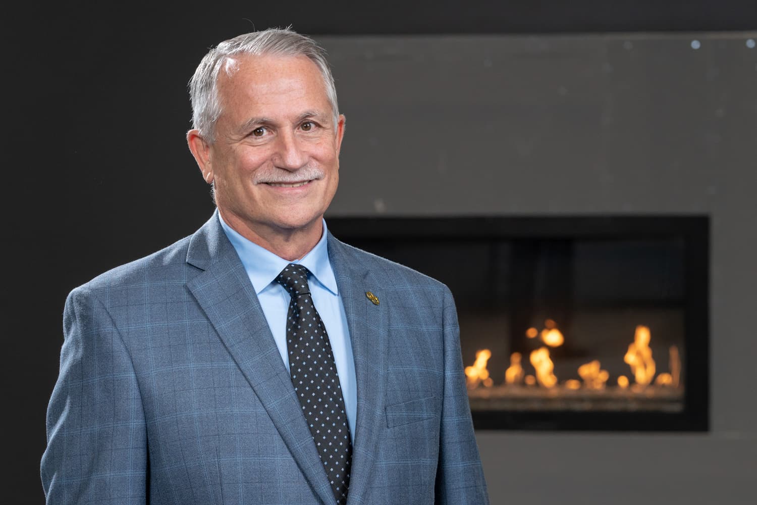  headshot portrait in front of fireplace 