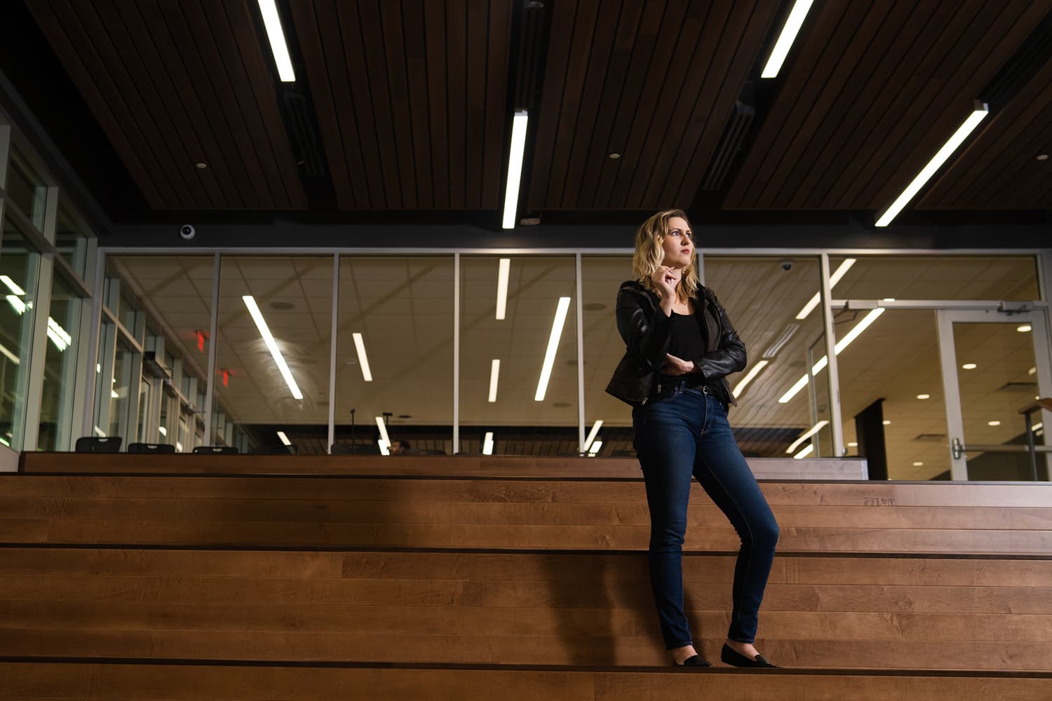  student on steps in front of windows 