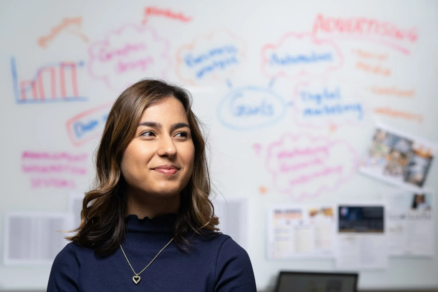 student portrait in front of white board with writing