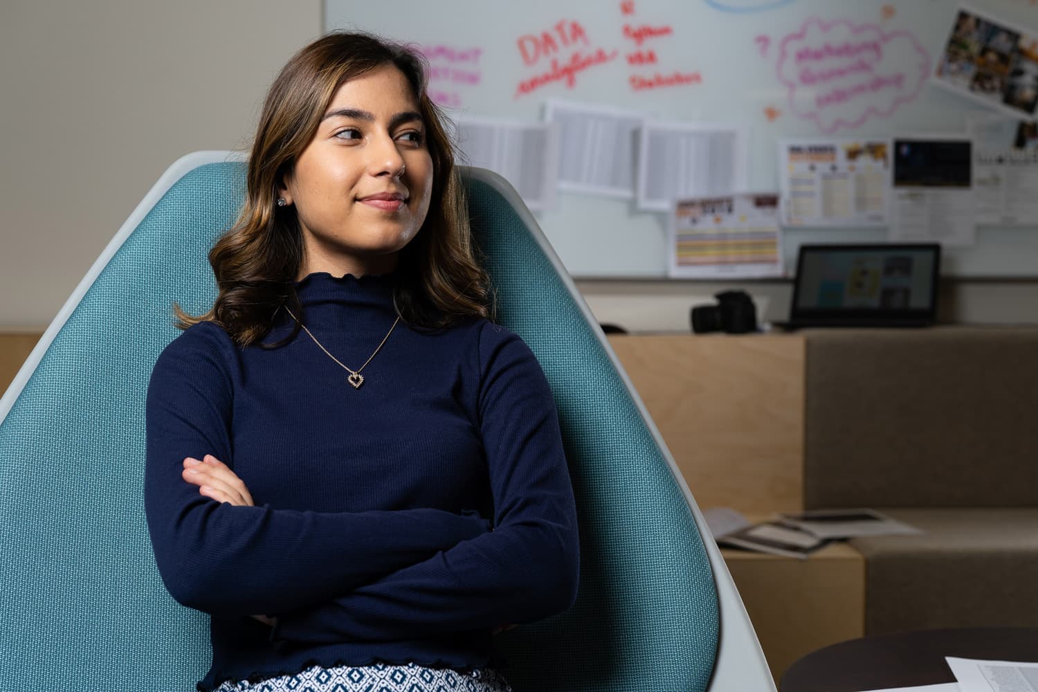  student sitting in chair with arms crossed. 