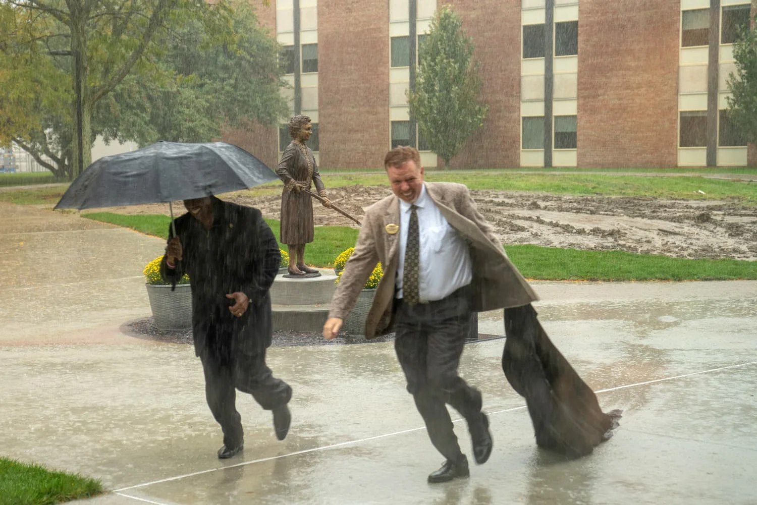 Matilda Wilson statue unveiled in the rain by Oakland University Vice President Michael J. Westfall and Chief Diversity Officer Glenn McIntosh