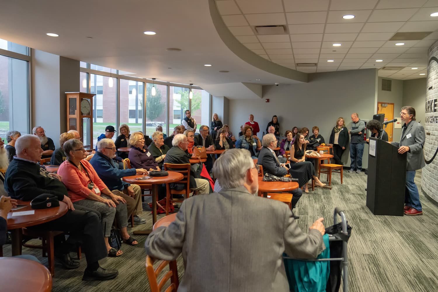 Artist of Matilda Wilson statue Lou Cella answering questions from crowd at Oakland University