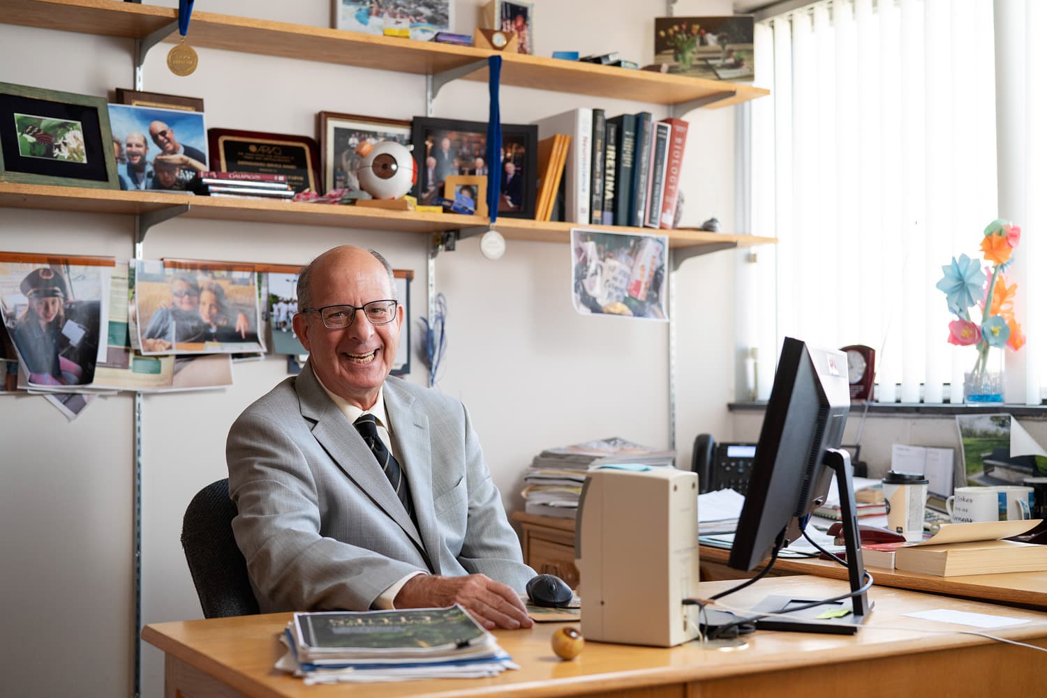  Doctor Barry Winkler smiling at desk in office 