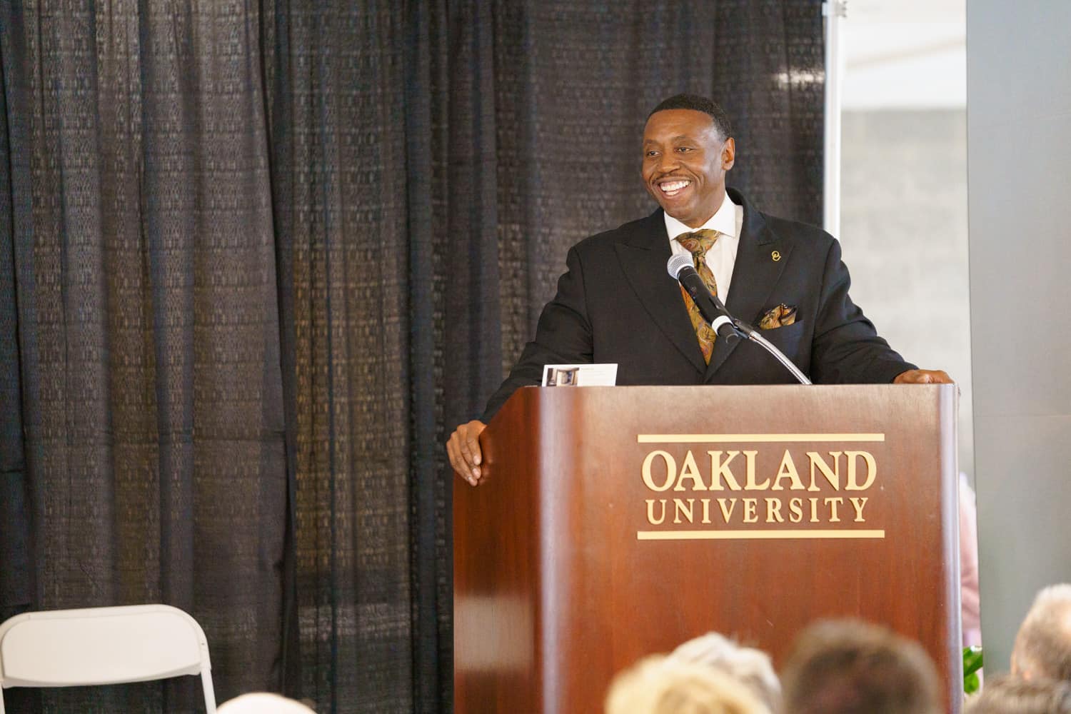  Glenn McIntosh speaking at podium during Hillcrest Hall grand opening 