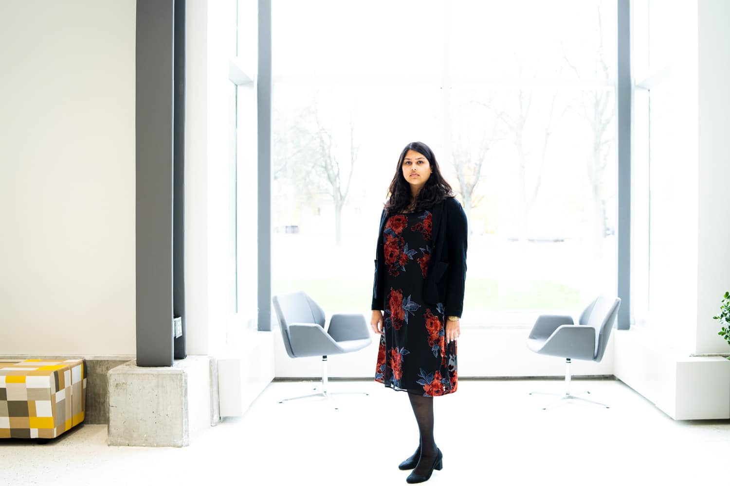  Student standing in front of large window 