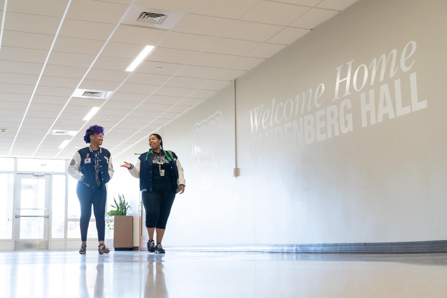  students walking in university hallway 