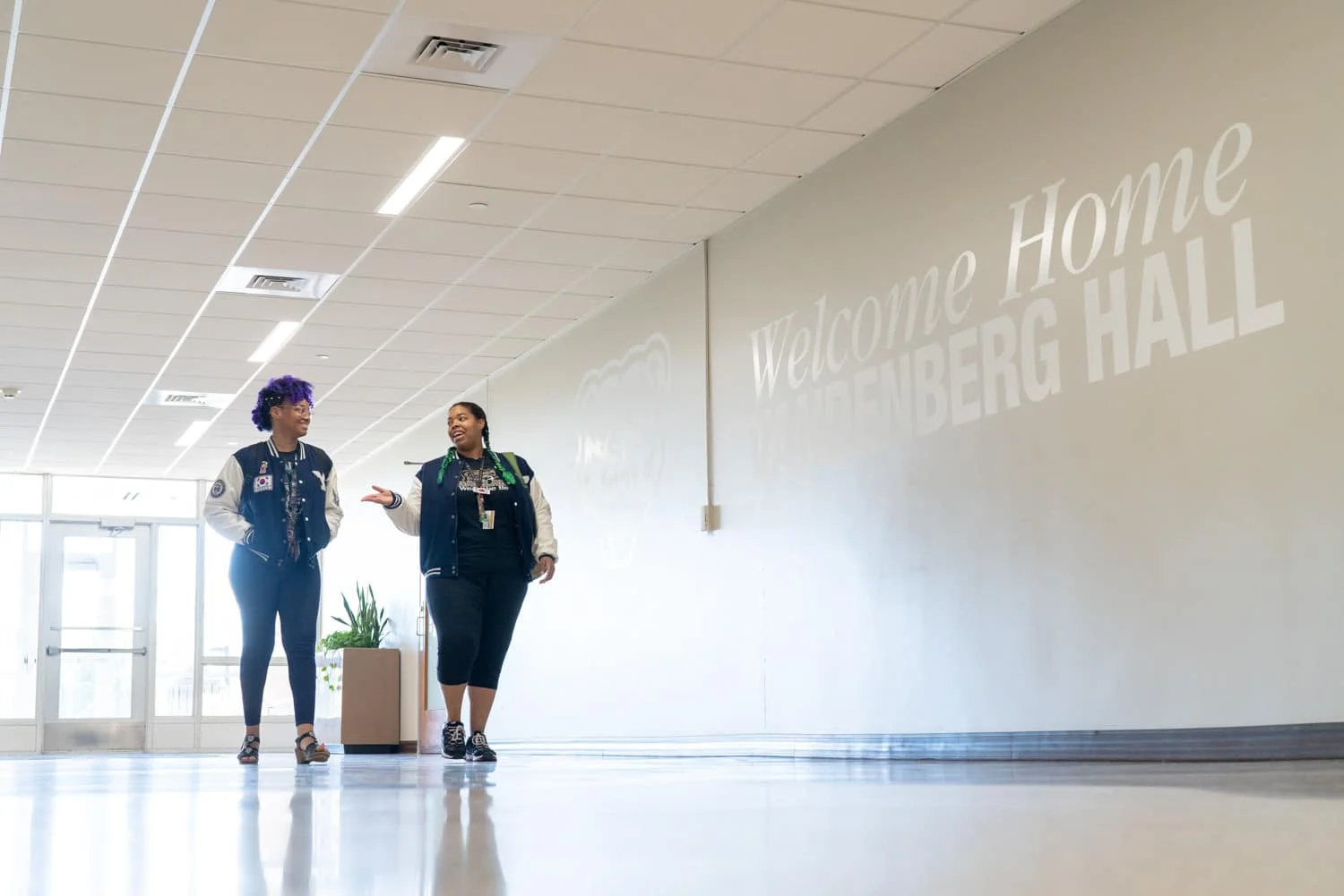 students walking in university hallway