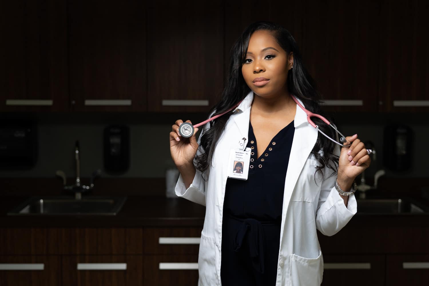  nurse practitioner in front of cabinets   