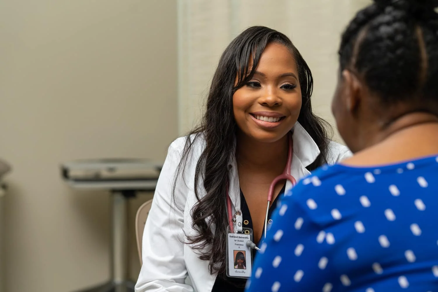nurse practitioner smiling at patient