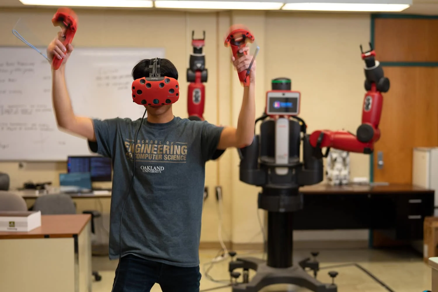 student controlling a robot with motion detection controllers
