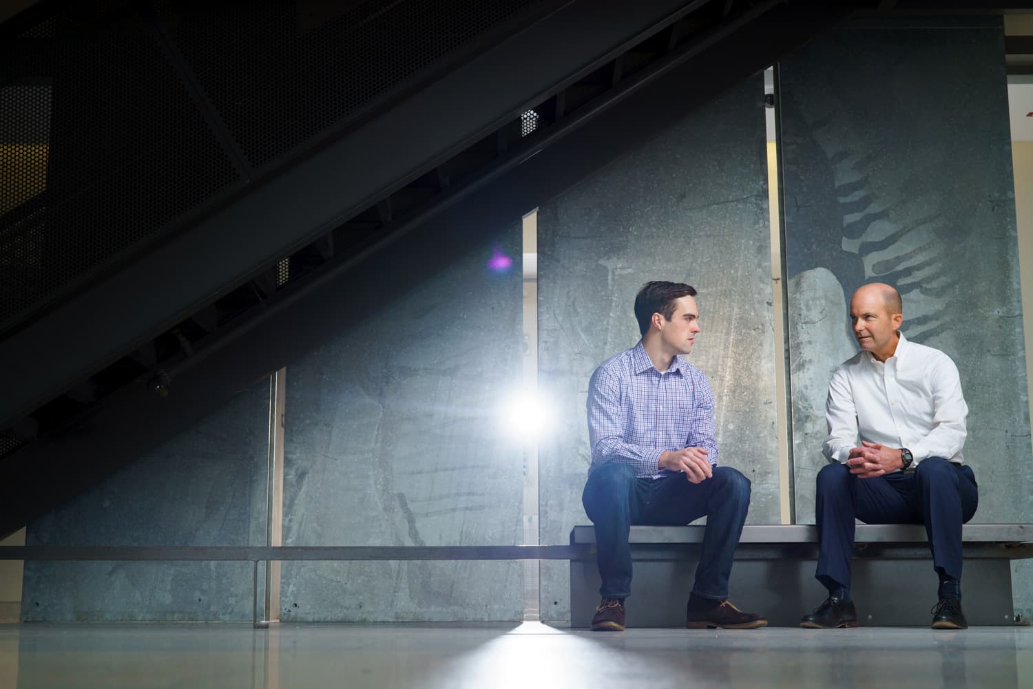  student and father talk on bench 