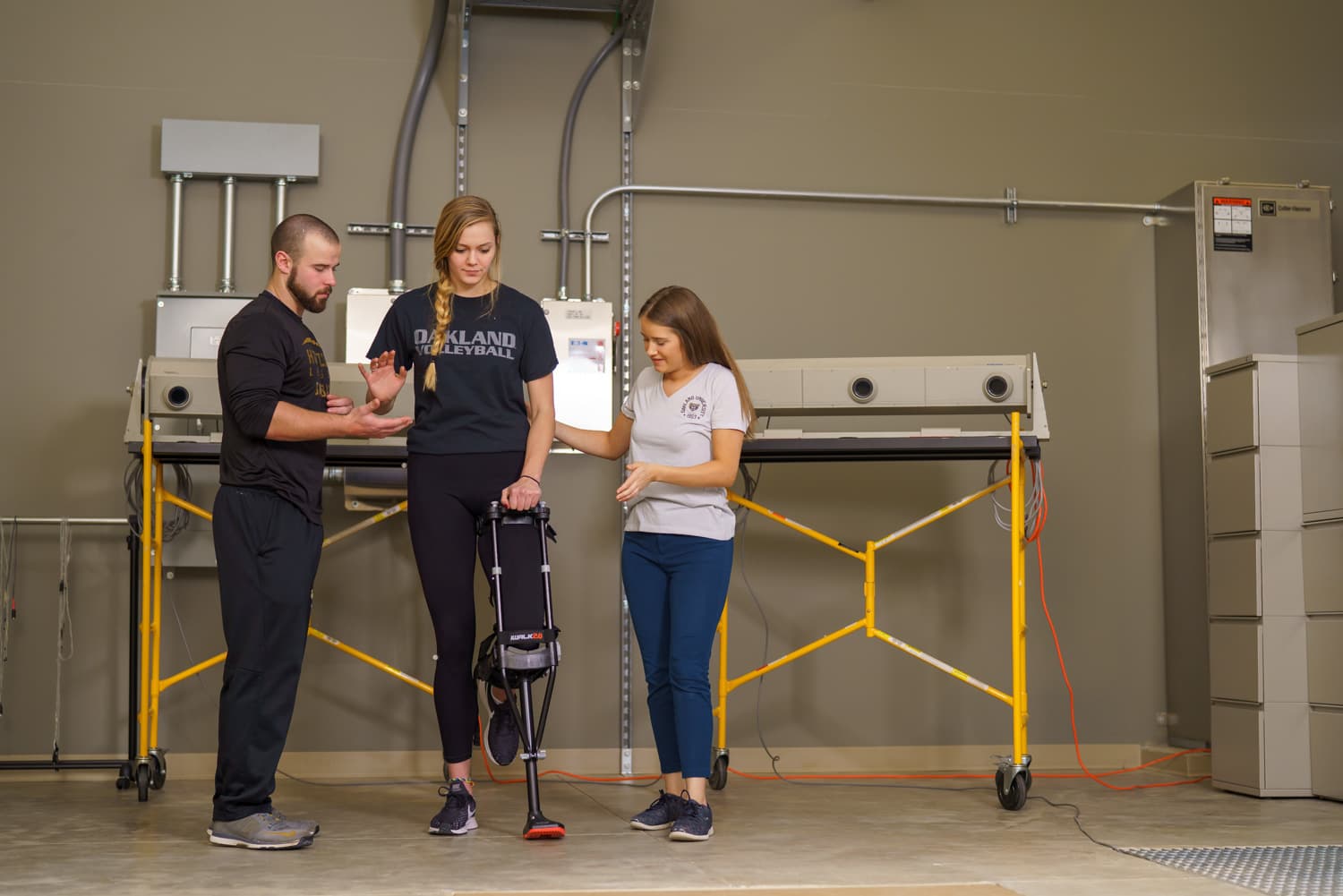  students assisting athlete while monitoring balance 