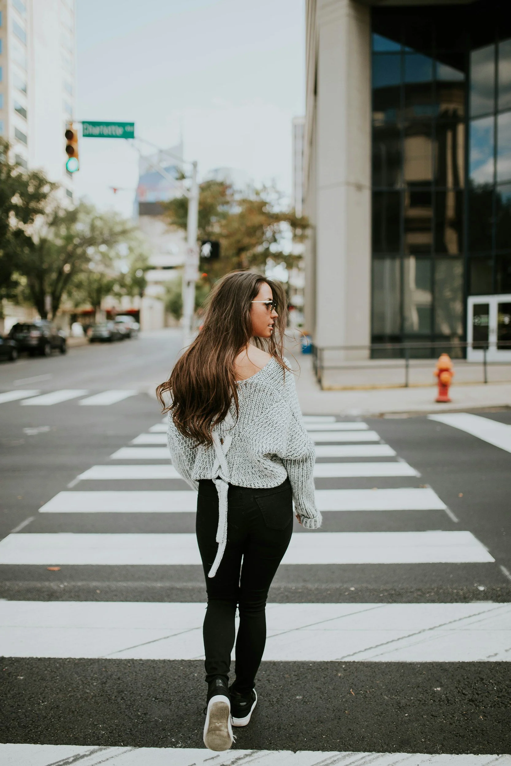 woman walking on city street asking herself a better question is: What kind of walk do I need today?