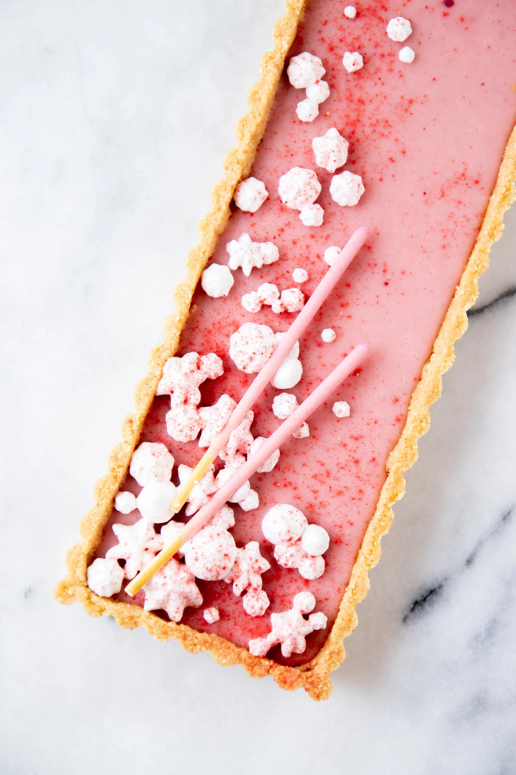 White chocolate ganache with pulverized freeze dried strawberries mixed in. Took a few tries to get that perfect Pocky flavor.