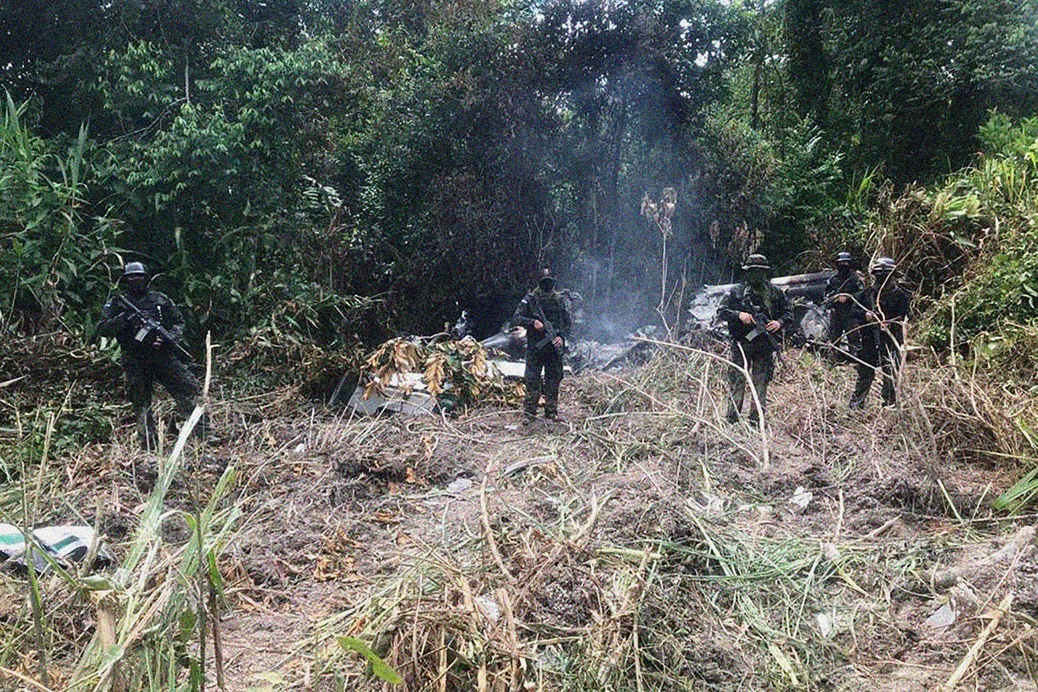  A picture taken by the Honduran military shows a special forces team as they pose in front of the wreckage of a plane transporting an indefinite amount of cocaine.  An army commander for Special Forces Operations in the Rio Platano Reserve lamented 