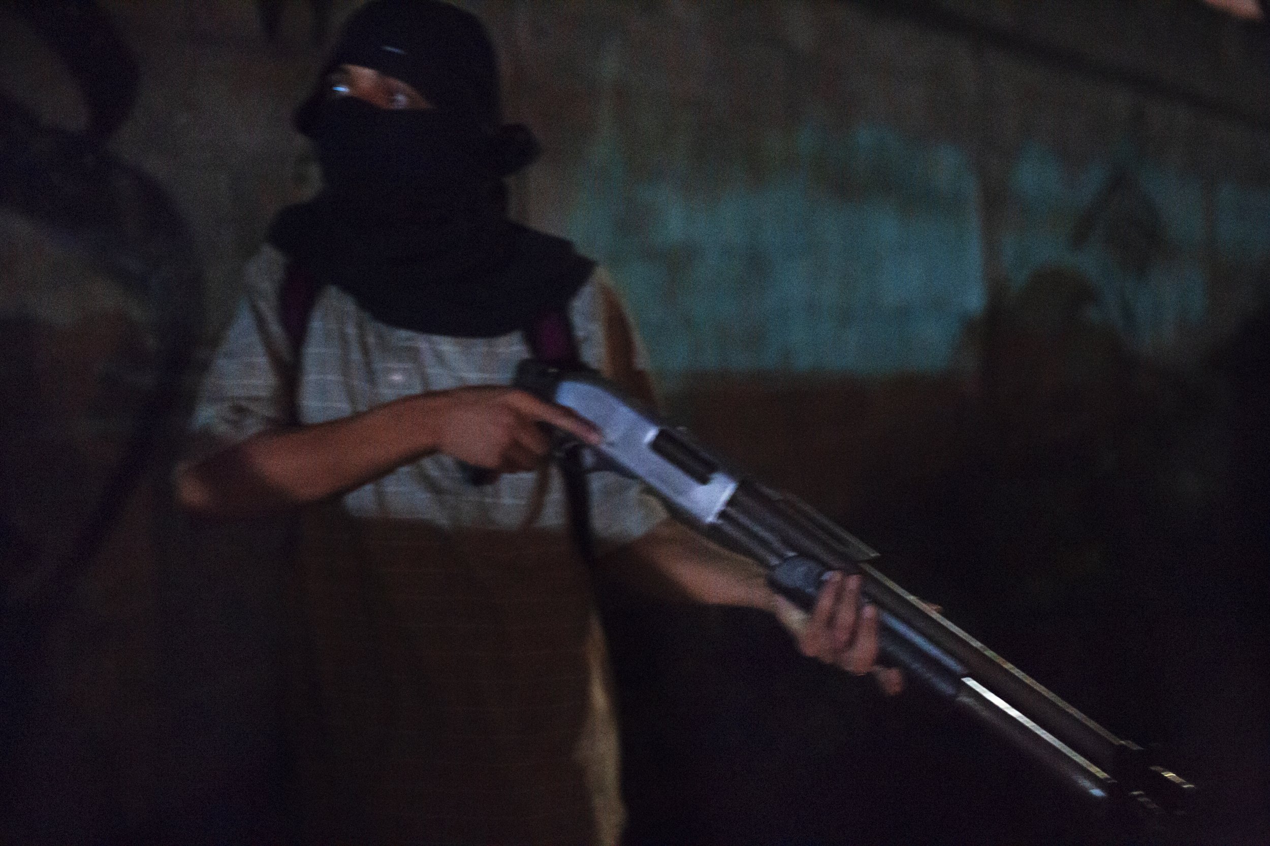  OZ (19yo), head of drugs distribution of 18th Street Gang, on patrol with his Chiappa C-9-12 pump action shotgun. Colonia Cerrito Lindo, San Pedro Sula, 2019 