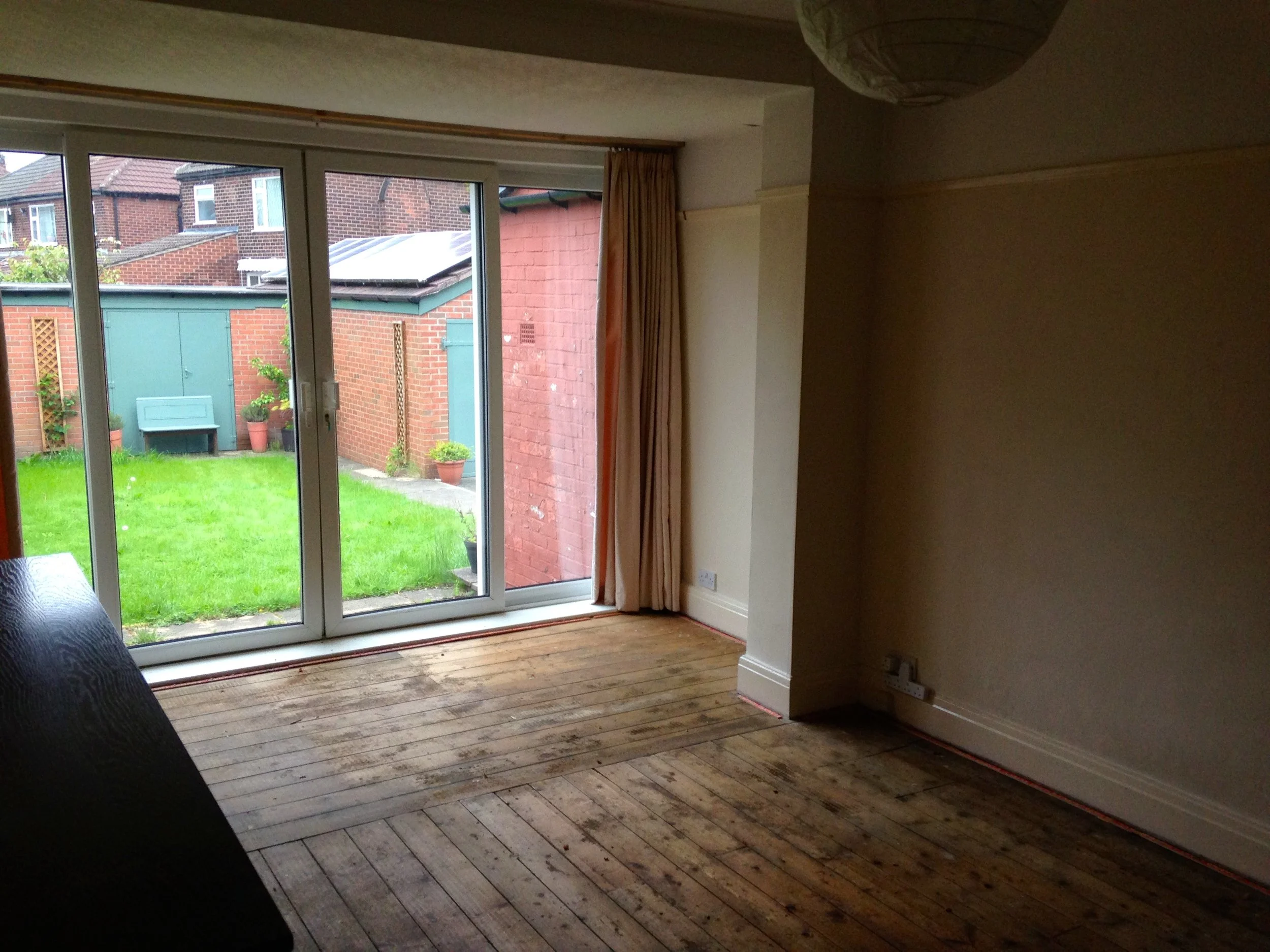 Separate galley kitchen and living room combined (before shot).