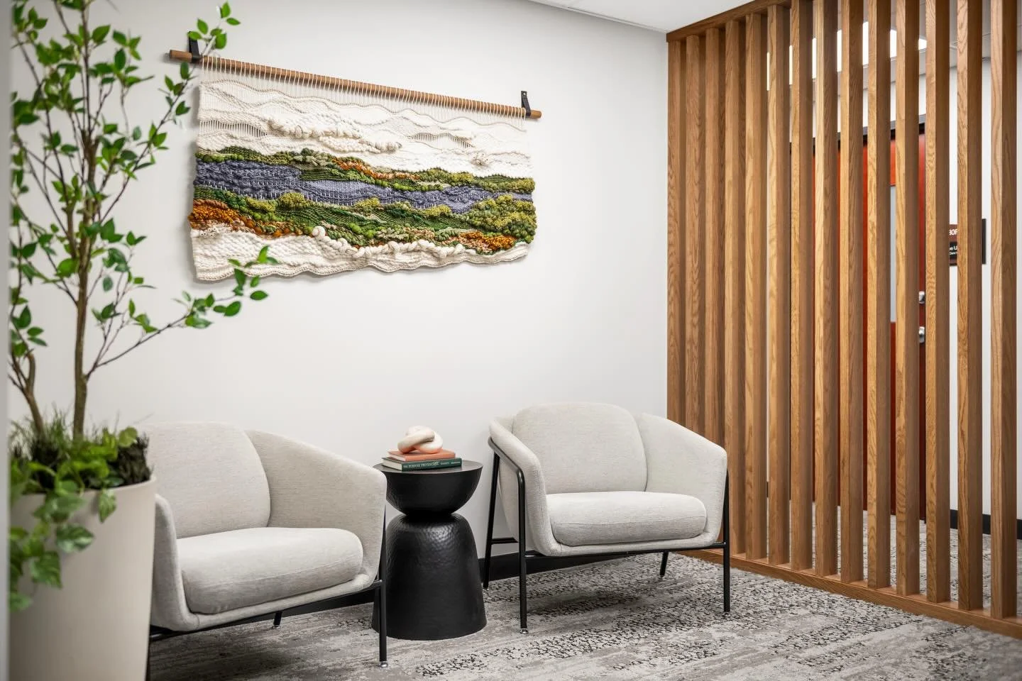 ELEVATED PAUSE
Soft textures, warm wood tones, and greenery come together to form nature-inspired waiting areas.

Local textile artist @kasiacymermanart created this commissioned tapestry titled &ldquo;prairie bluffs&rdquo; for the wellness suites. K