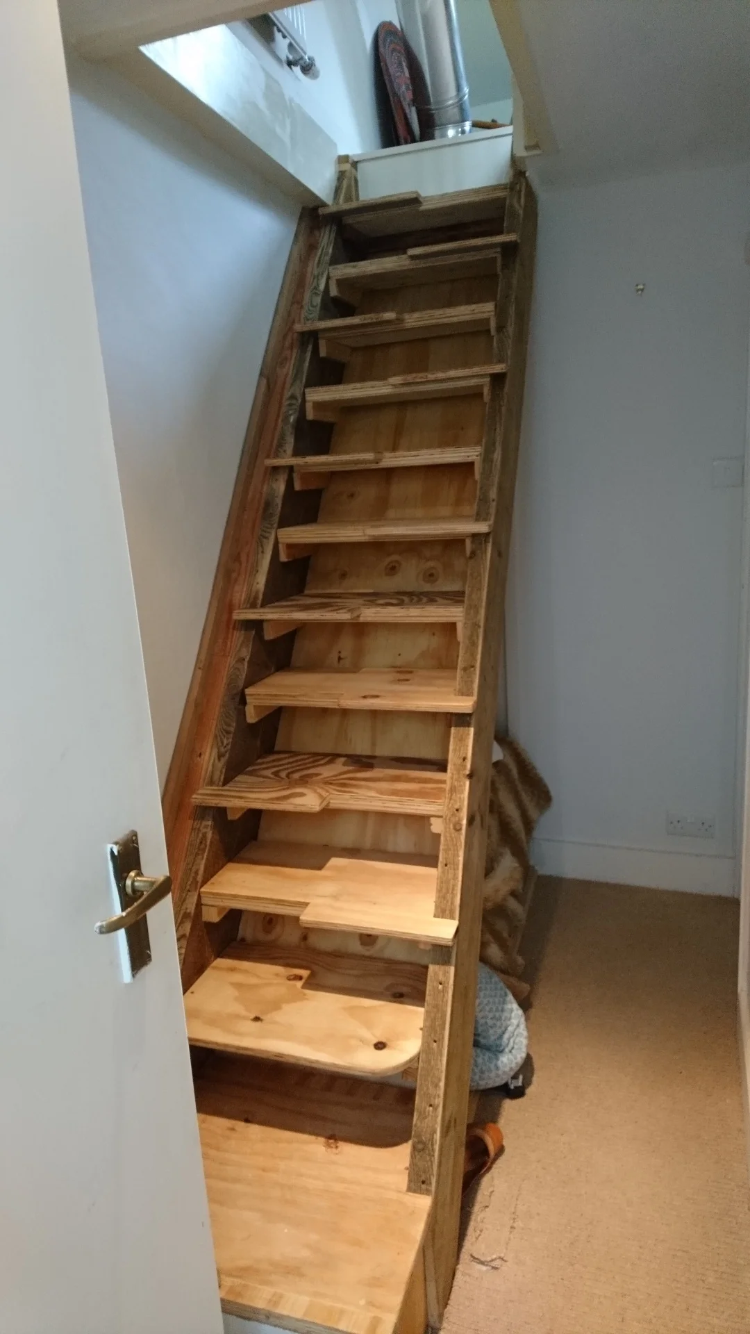  Here a loft ladder is replaced with a space saver staircase made from floor joists and ply wood. 