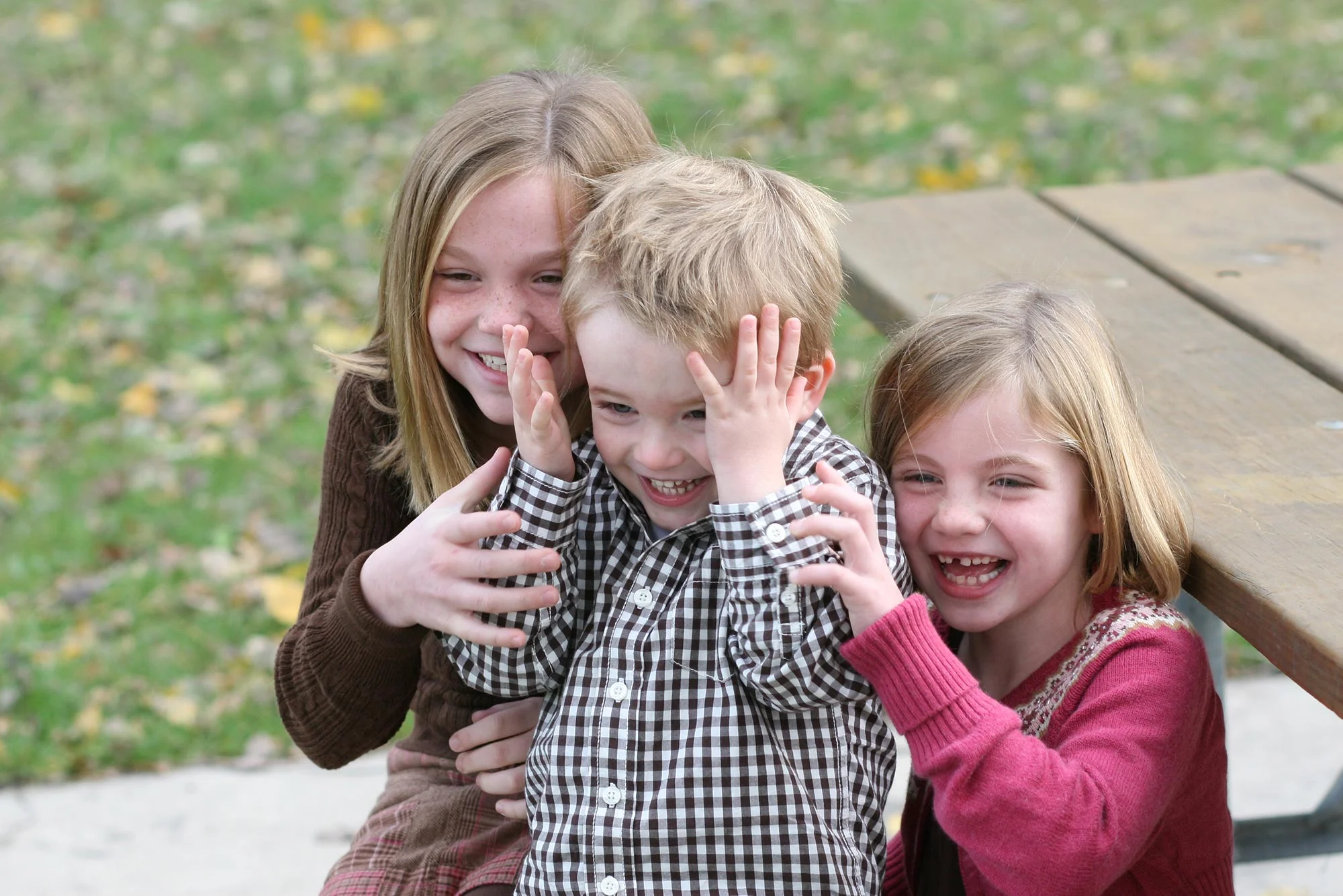 Three Siblings Laughing on Picnic Table  |  LaPanta Photography  |  Candid Photos of Children and Outdoor Family Photos |  Shoreview, MN