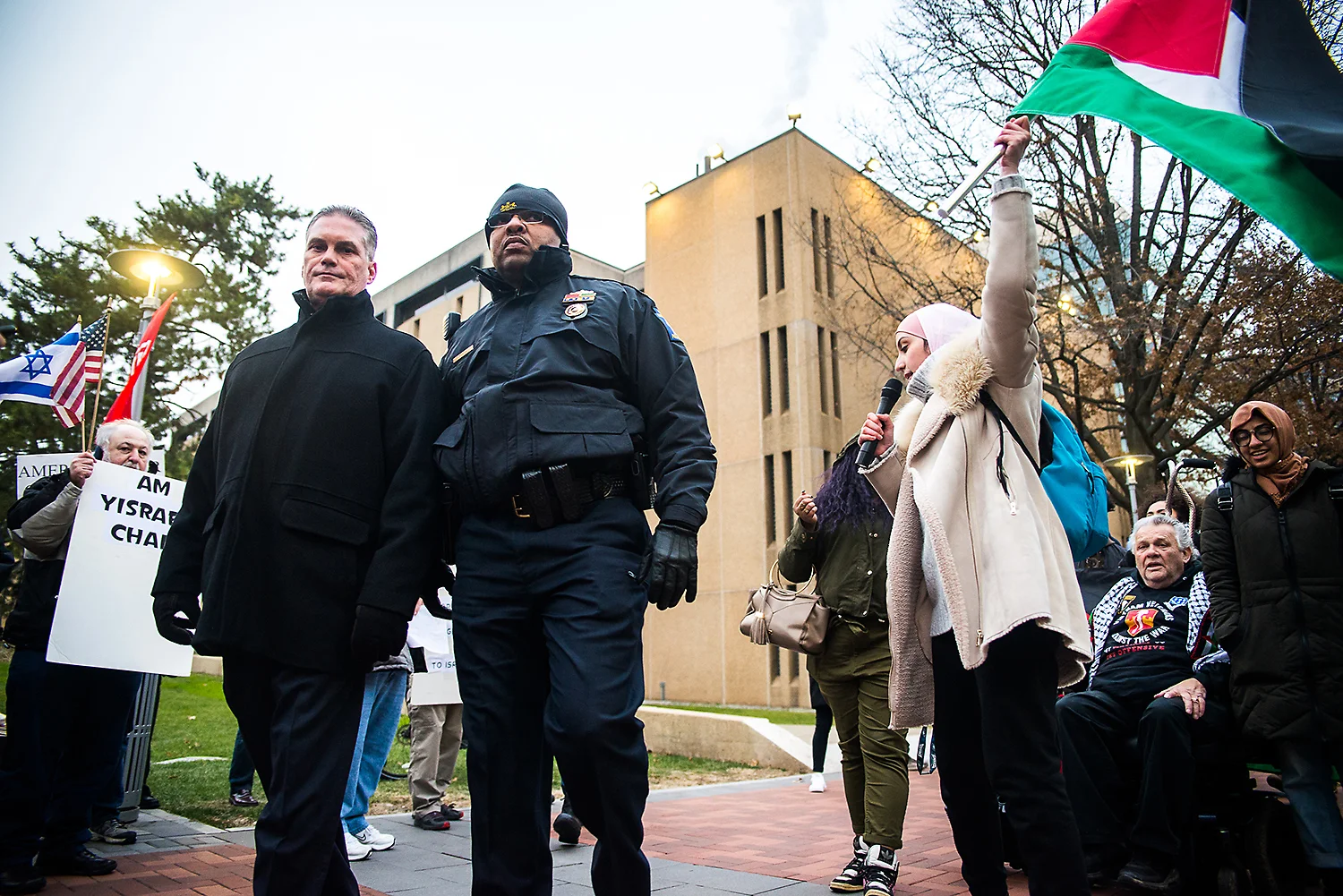  Police officials walk in between Palestinian and Jewish protest groups during a pro-Palestine rally at the Bell Tower on Temple University’s Main Campus on Dec. 6, 2018. | The Temple News 
