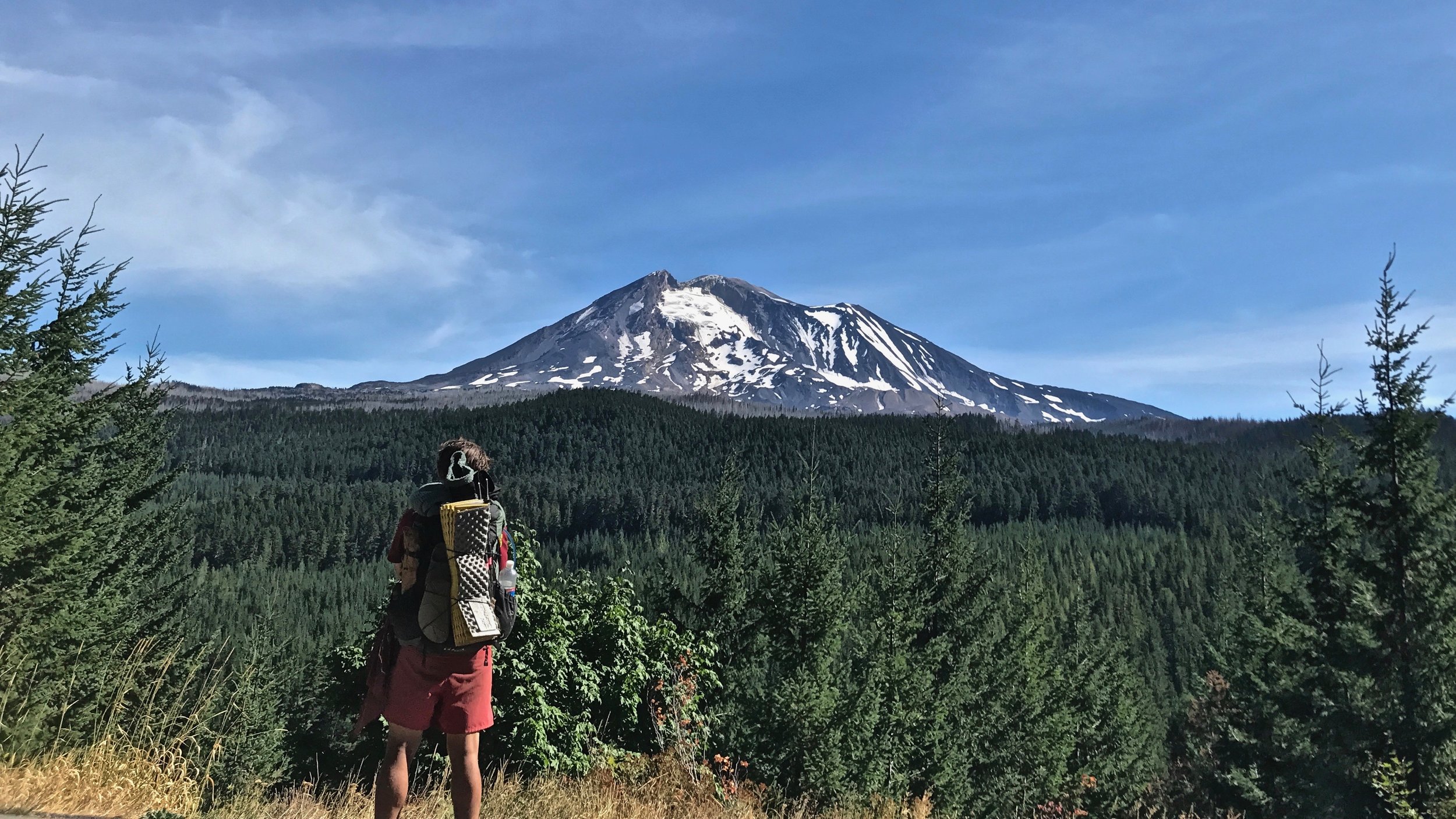 Alex and Mount Adams on the road walk back to trail