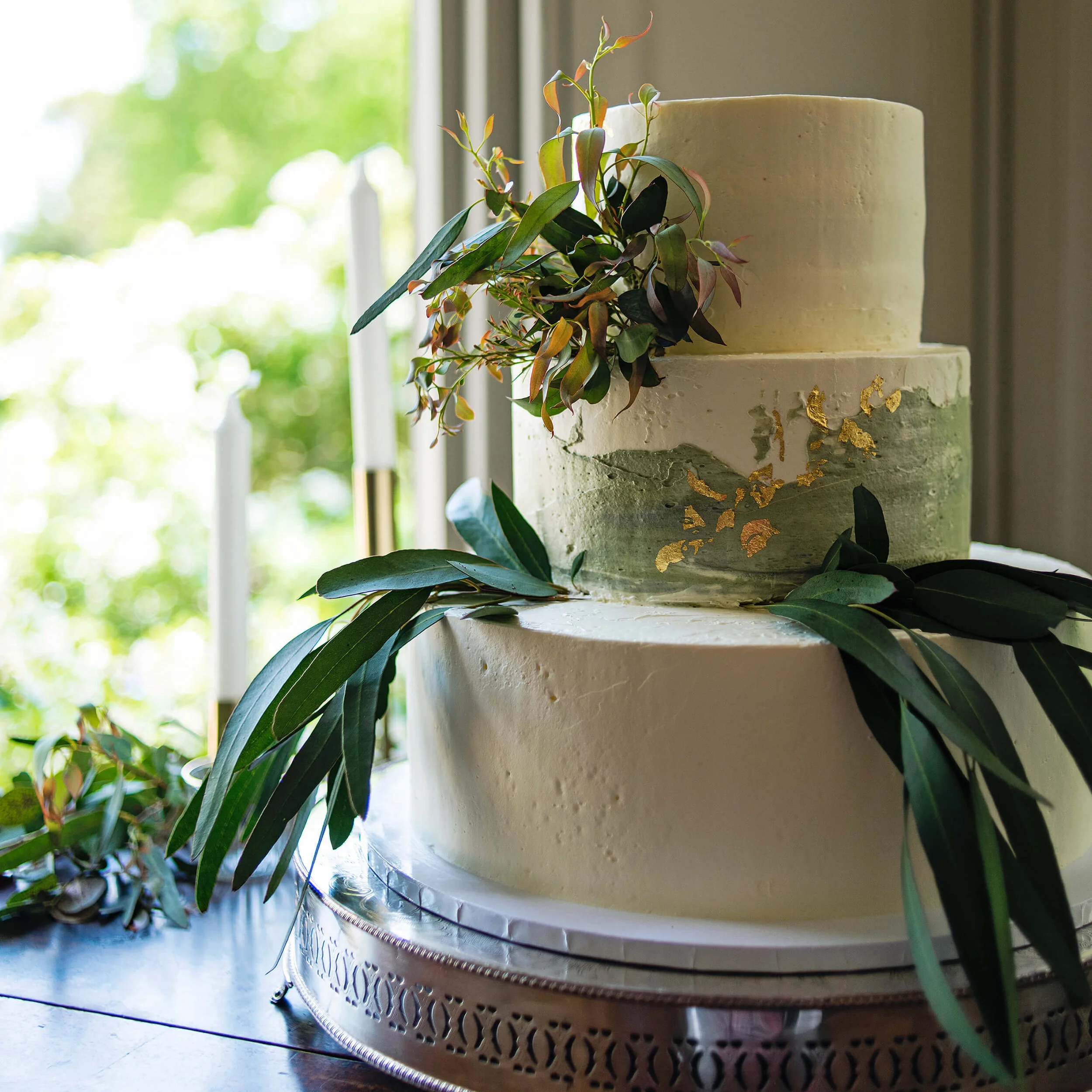 Cakes & Leaves Three Tier Eucalyptus Foliage and Gold Leaf Wedding Cake details at Nurstead Court Wedding venue, Kent.