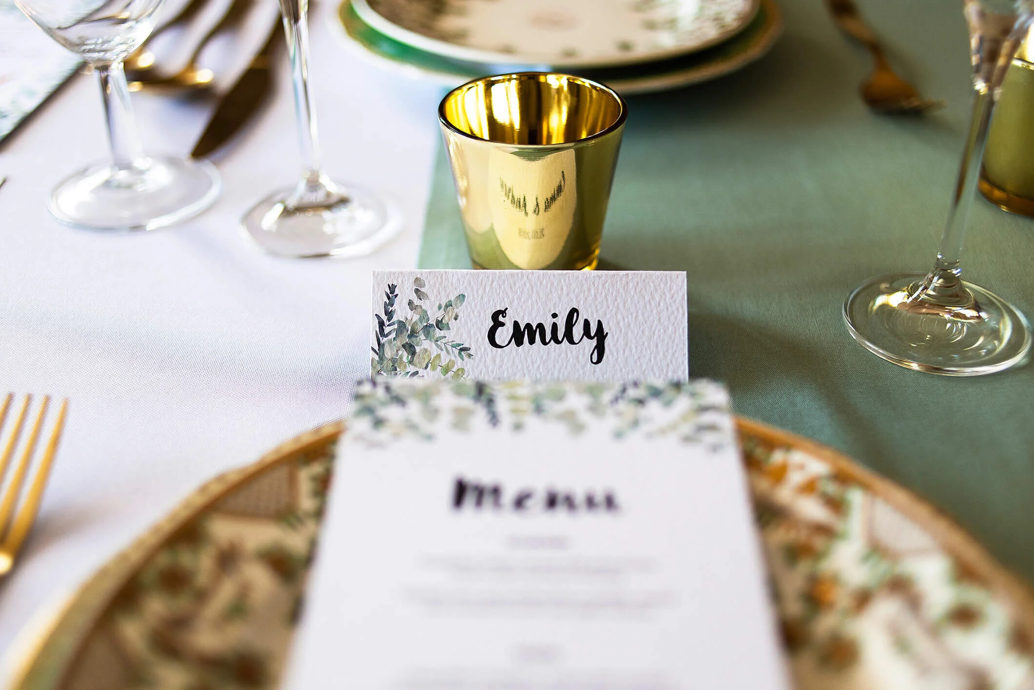 Design By Emily Rustic Eucalyptus Wedding Menu on plate and place name card, at Nurstead Court Wedding Venue, Kent.